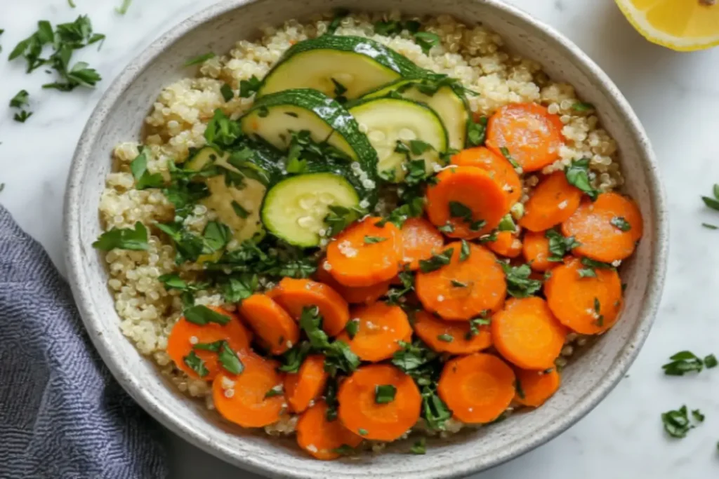 Sautéed carrots and zucchini served over quinoa with fresh herbs.